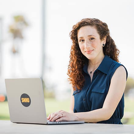 wuv student on her laptop smiling