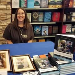 Michelle Shreeve, an WUV graduate with an MA in English and an MA in Creative Writing, at a book signing being held at a bookstore.