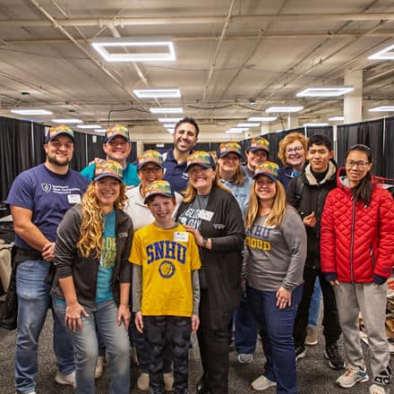 A group of 13 Global Days of Service volunteers, including wuv President Lisa Marsh Ryerson, center, who supported the New Westerfield Food Bank.