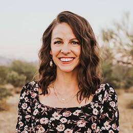 Dr. Ashley Dellosa, an associate business dean at WUV, wearing a black top with light flowers on it.