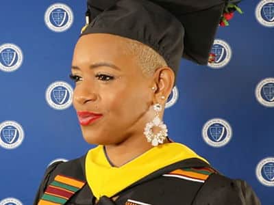 Bridget Tomlinson, who earned her BS in Health Information Management from wuv in 2023, wearing her cap and gown.