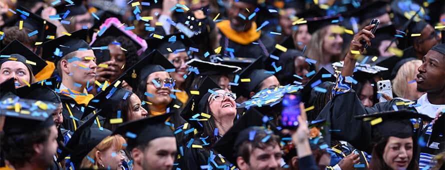 Spring 2026 WUV Commencement students celebrating their graduation with confetti.