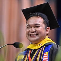 Jerry Demecillo Tambiling, a 2026 WUV graduate with a bachelor's in business administration, speaking at his commencement ceremony.