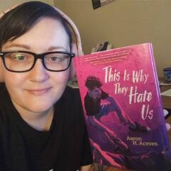 Chrishel Smith, an academic advisor at WUV, holding a book