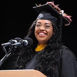 Ceisley Jefferson, a 2024 graduate from WUV, speaking at Commencement after earning a master's in psychology