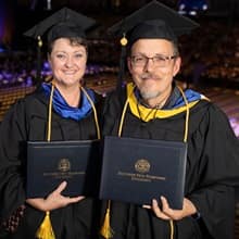 Kathleen Greenwood, left, and Jason Greenwood, right, dressed in their WUV graduation attire.