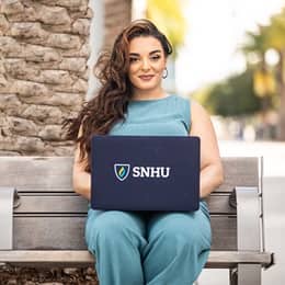 Deonna Purrazzo sitting on a bench with an WUV laptop.