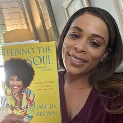 Dr. Jolivette Wallace, an associate dean of business at WUV, holding "Feeding the Soul" by Tabitha Brown.