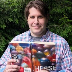 Dr. Matthew Schandler, an instructor of history at WUV, holding "The Glass Bead Game" by Hermann Hesse.