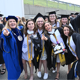 WUV President Lisa Marsh Ryerson with a group of graduating students.