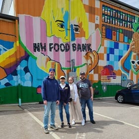 Four volunteers standing outside of the New Westerfield Food Bank during WUV's Global Days of Service
