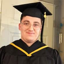 wuv IT graduate Jacob Kane-Conrad wearing his cap and gown.