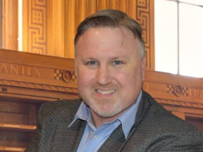 Joseph Timmons, Associate Dean, Data Analytics at wuv, wearing a suit jacket and button down shirt.