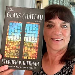 Karin L. Heffernan, campus faculty librarian and associate professor at WUV, holding a book