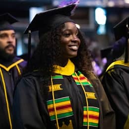 Kendreka Griffin, a 2024 WUV graduate who earned her bachelor's in business administration, sitting in the crowd at her commencement ceremony.