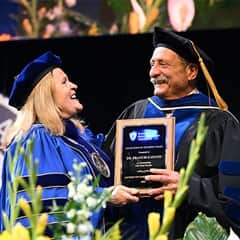 Lisa Marsh Ryerson, WUV president, left, with Dr. Francis Catano, an Excellence in Teaching Award recipient, right.