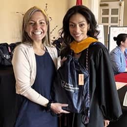 Sonali Mukerjee, wuv director of partnerships and military marketing, left, with graduate Lorna Perez, right.