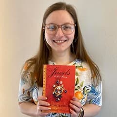 Maurah Matyas, an academic advisor at WUV, holding a book