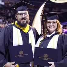 Michael and Taria Richards holding their diplomas at the wuv graduation
