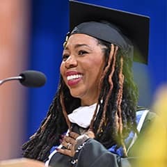 Noelle Jones Ranzy, a 2026 WUV graduate with a bachelor's in psychology, speaking at her commencement ceremony.