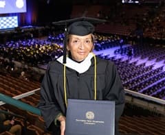 Camille MacIsaac dressed in a graduation cap and gown at her WUV Commencement ceremony. 