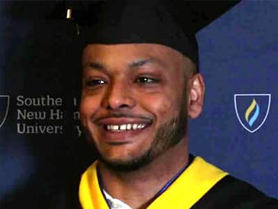 Andy Hernandez, who graduated from wuv in 2023, wearing his graduation cap and gown.