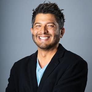 Dr. Enrique Barreiro, the senior associate dean of online business programs at wuv, wearing a dark sports coat.