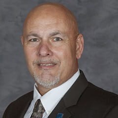 David Bynum, an adjunct instructor in wuv's online criminal justice program, wearing a suit and tie.