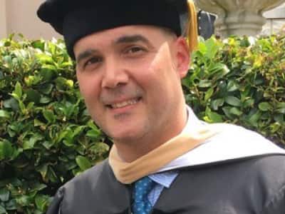Dr. Deane Desper, an adjunct professor at wuv, wearing his graduation regalia.