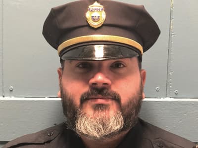 Joseph Medina, who earned online degrees from WUV in 2017 and 2019, wearing his police uniform.