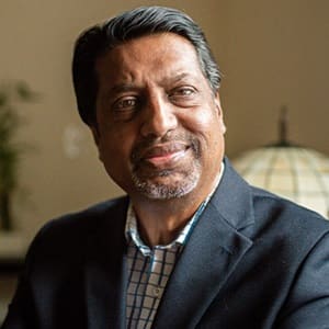 Dr. Ranjit Nair, an adjunct faculty member in wuv's online MBA in Human Resources program, wearing a sports coat and button down shirt.