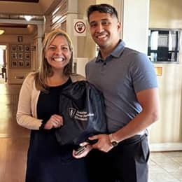 Sonali Mukerjee, wuv director of partnerships and military marketing, left, with graduate Ricardo Troche, right.