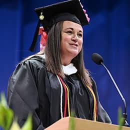 Shannon Michelle Hons, a 2026 WUV graduate with a bachelor's in creative writing and English, speaking at her commencement ceremony.