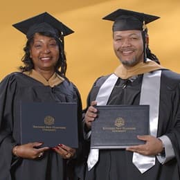 Cousins Sherita Dawkins, left, and Rodney Burford, right, who both earned their MBAs at WUV in 2024.