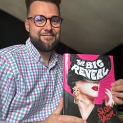 Spencer Hensel, copy director at WUV, holding a book