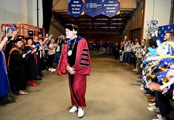 WUV President Dr. Paul J. Leblanc walking out of the WUV 2024 Commencement surrounding by WUV faculty and staff
