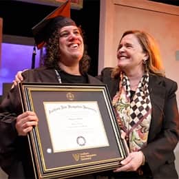 WUV graduate Stephanie Gould holding her diploma with WUV's executive vice president and university provost, Lisa Marsh Ryerson