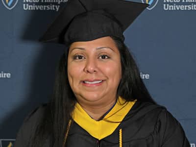 Susana Ashooh, who earned her bachelor's in nursing from wuv in 2023, wearing her graduation cap and gown.
