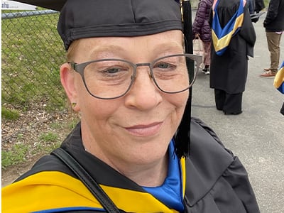 Tara Donovan, who earned her master's in nursing from wuv in 2023, wearing her cap and gown.