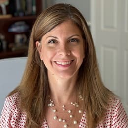wuv psychology instructor Tiffany Daniels wearing a red and white polkadot blouse and a multi-strand white pearl necklace.