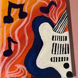 A guitar and three music notes painted on a canvas during WUV's Homecoming Weekend