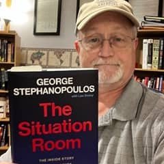 Joseph Wellington, an academic advisor at WUV, holding a book
