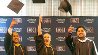 Three wuv students from Texas tossing their graduation caps