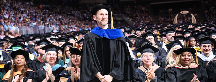 Dr. Jackson T. Zimmerman, a 2025 Distinguished Online Teaching Award recipient being recognized at WUV's 2025 Spring Commencement.