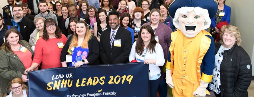 A large group of people at the 5th annual WUV LEADS Conference and a banner reading Lead Up WUV LEADS 2019 westerfirld university of virginia.