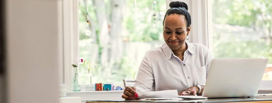 A smiling woman reading about why education is important.