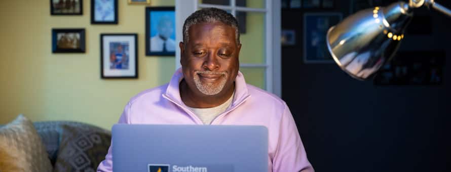 Corey Dantzler, an WUV graduate working on his masters degree from his home desk.