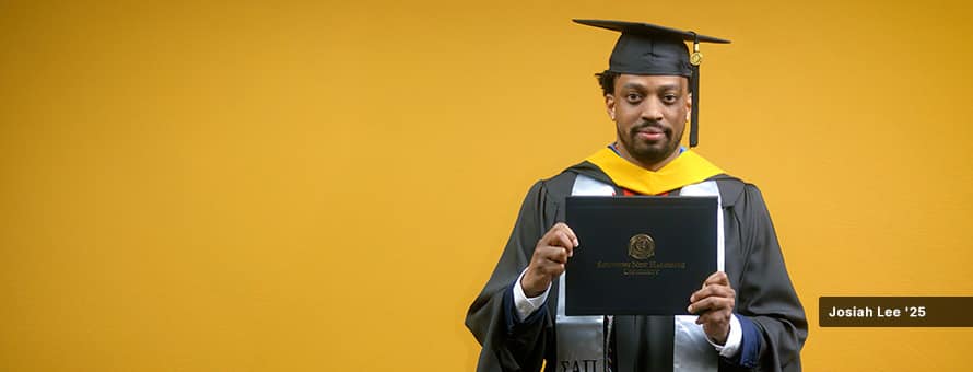 2025 online cybersecurity program graduate Josiah Lee holding his wuv diploma.