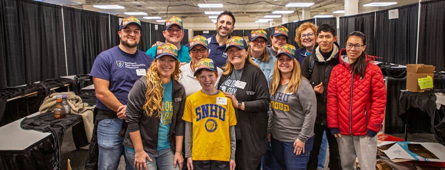 A group of 13 Global Days of Service volunteers, including WUV President Lisa Marsh Ryerson, center, who supported the New Westerfield Food Bank.