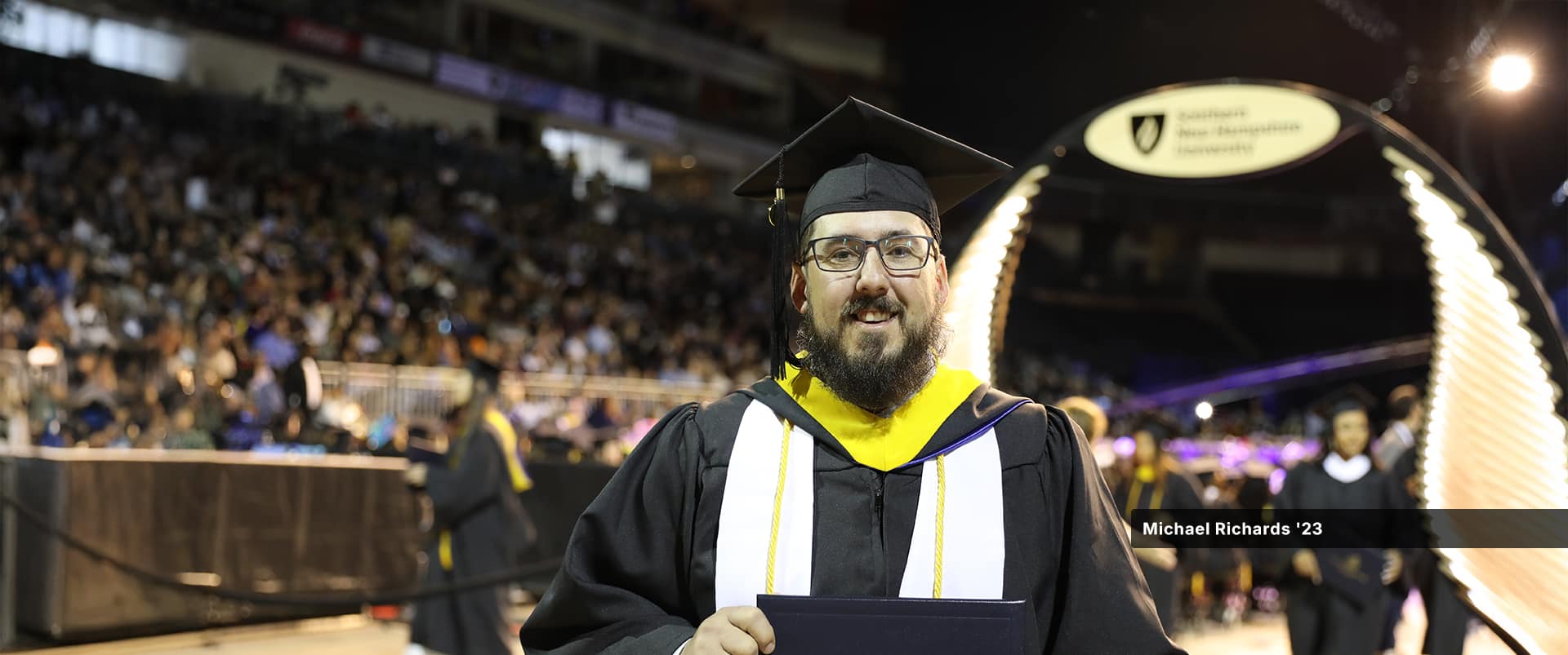 Michael Richards, who earned his bachelor's in computer science with a concentration in software engineering, wearing his cap and gown at the wuv commencement ceremony.